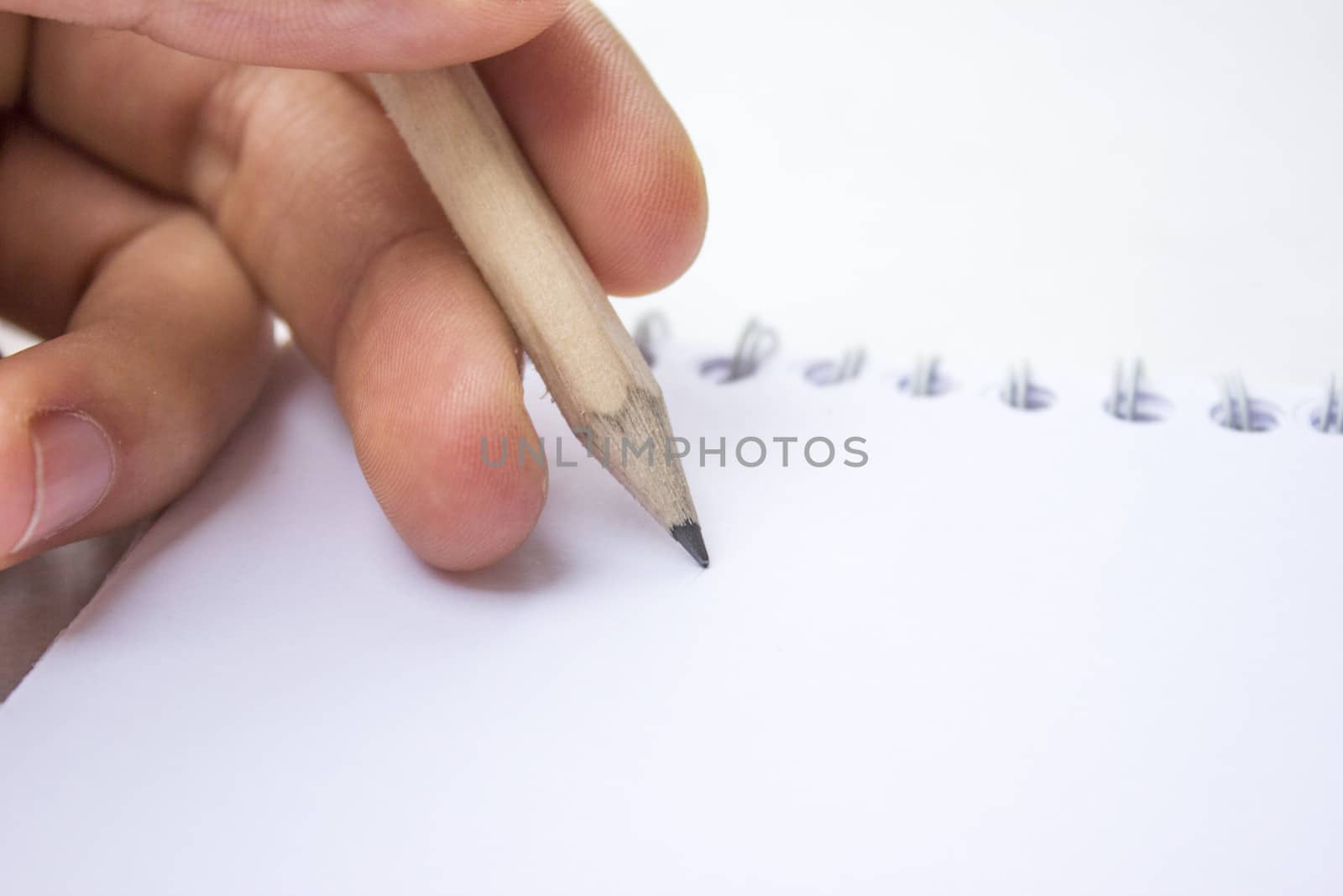 Pencil in a composition with a blank book with hardcovers.