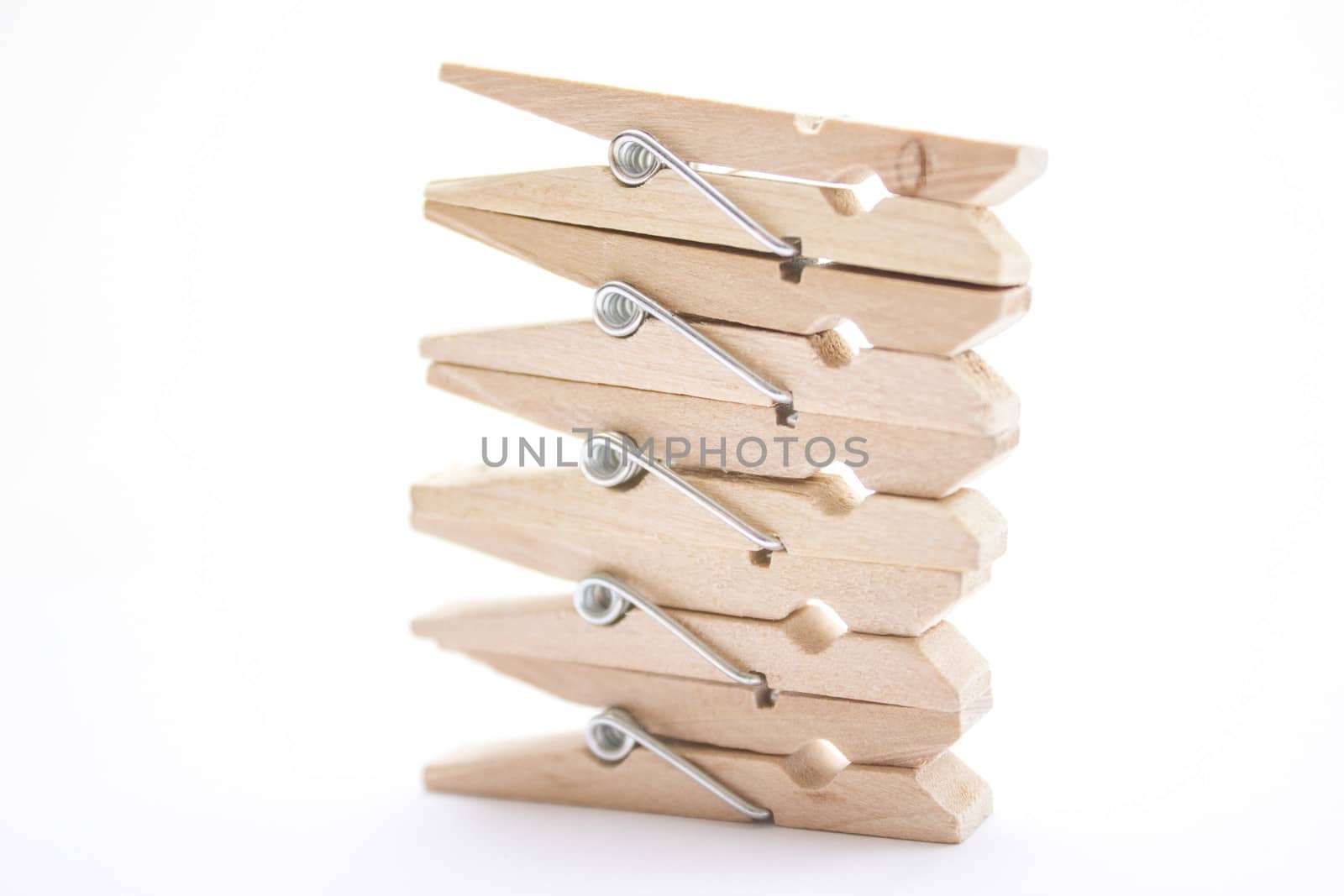 Composition of several wooden pegs on a white background.