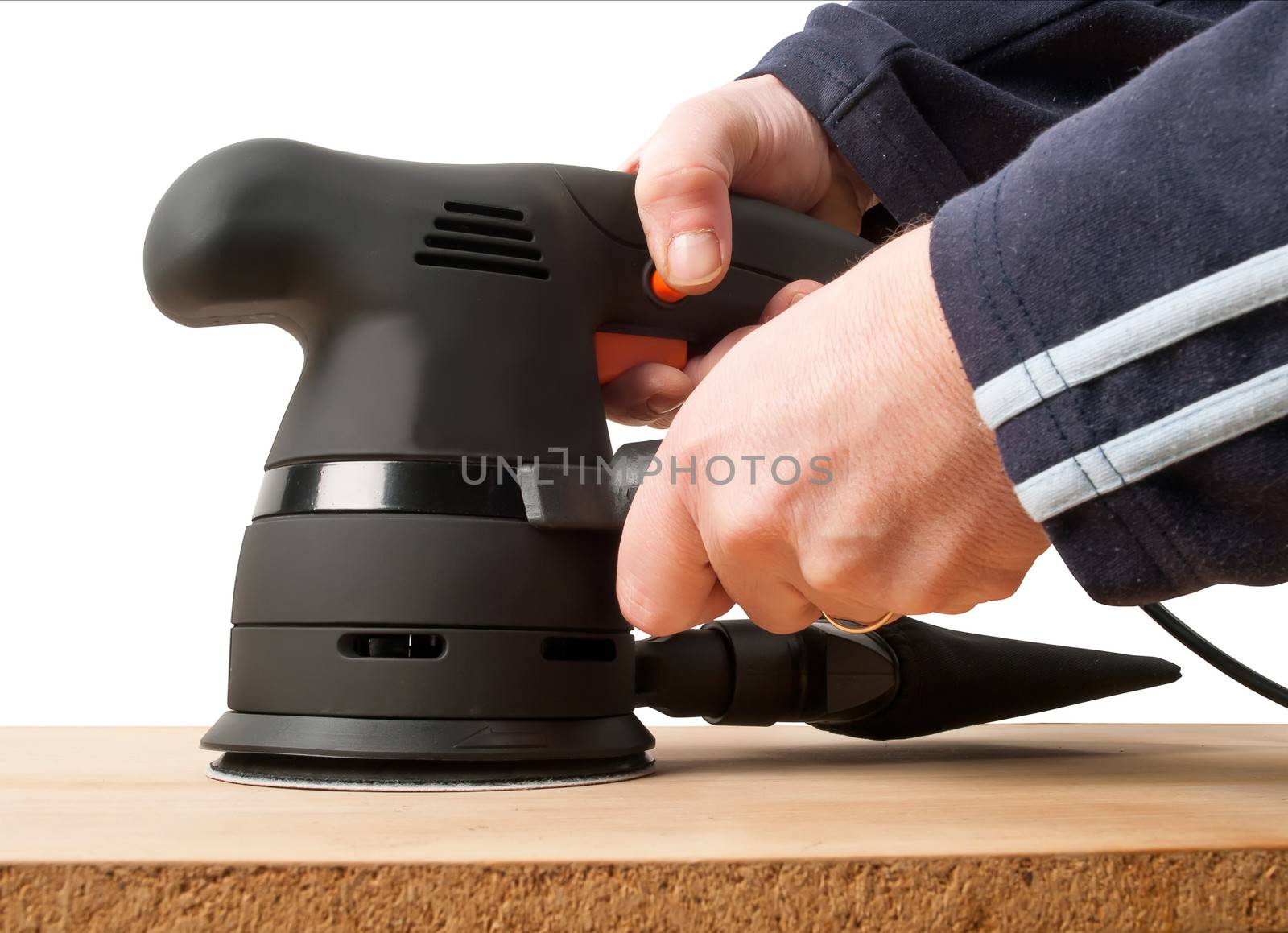 worker with sander machine working on wooden surface