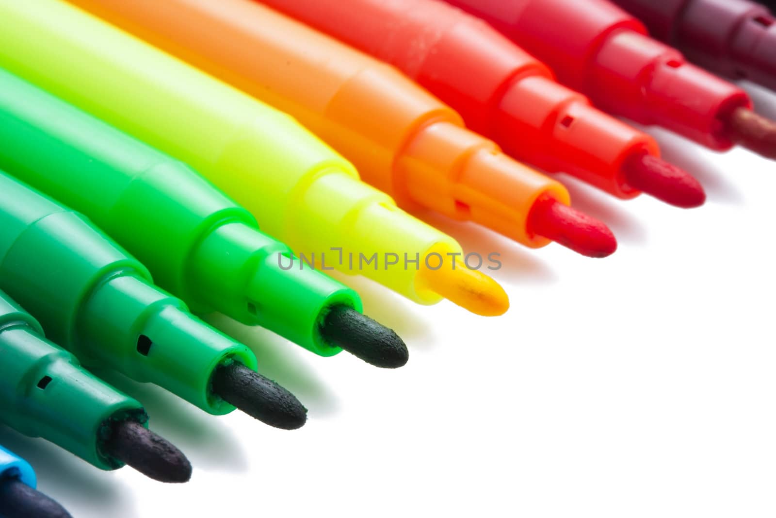 Group of felt tip bright color markers on white background