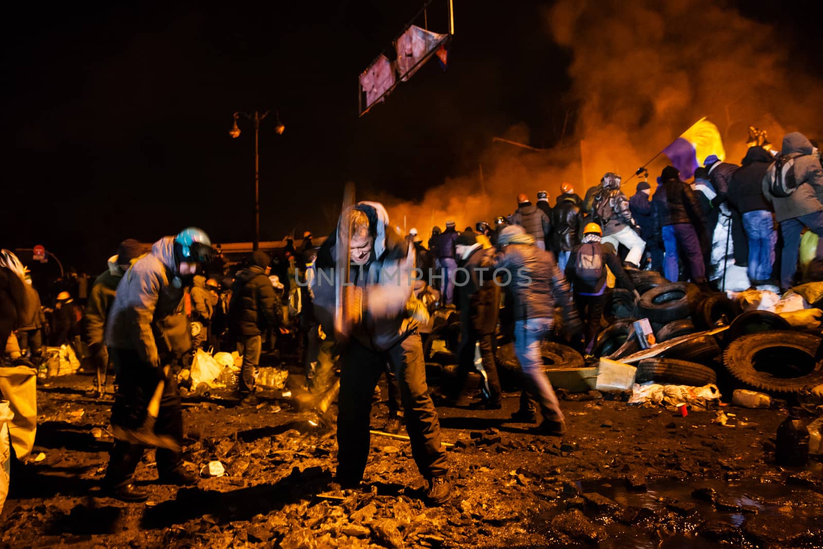 KIEV, UKRAINE - January 24, 2014: Mass anti-government protests in the center of the Ukrainian capital Kiev. Popular Resistance Warrior preparing to storm by government troops  on Hrushevskoho St.
 