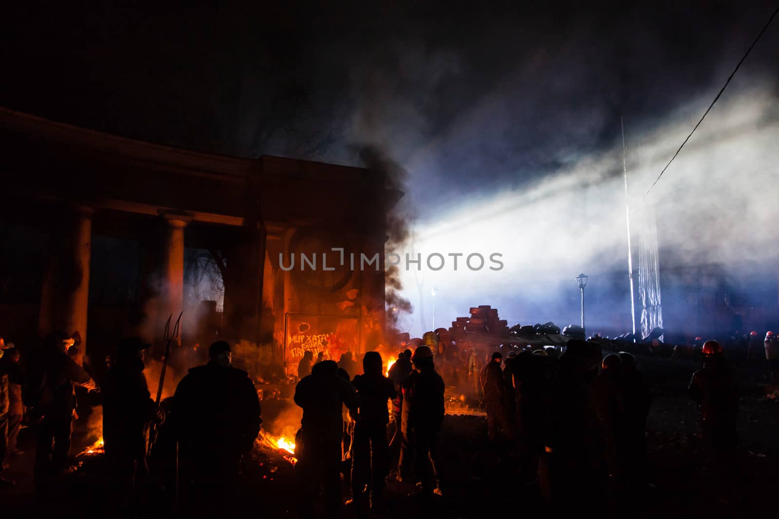 KIEV, UKRAINE - January 24, 2014: Mass anti-government protests in the center of the Ukrainian capital Kiev. Popular Resistance Warrior preparing to storm by government troops  on Hrushevskoho St.
 