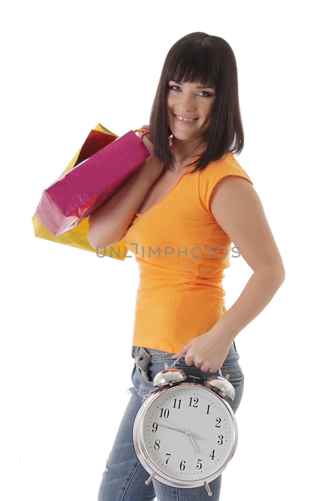 Smiling girl with shopping begs and clock over white, shopping time concept