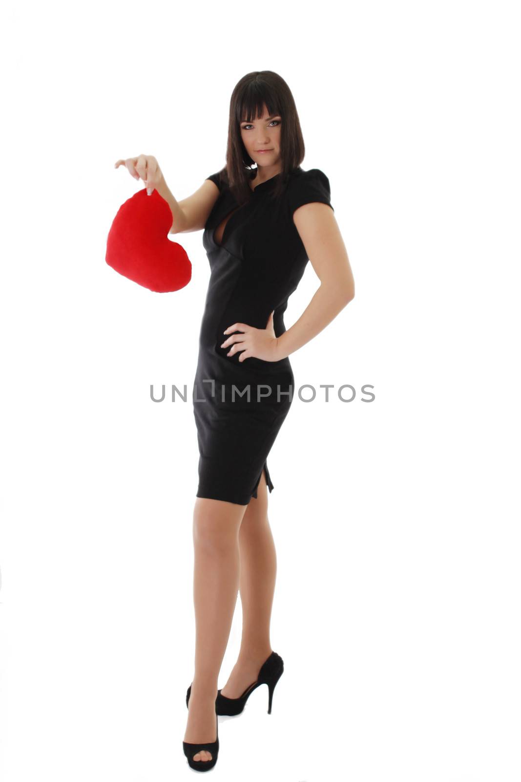 Elegant woman in dress and heels holding heart over white
