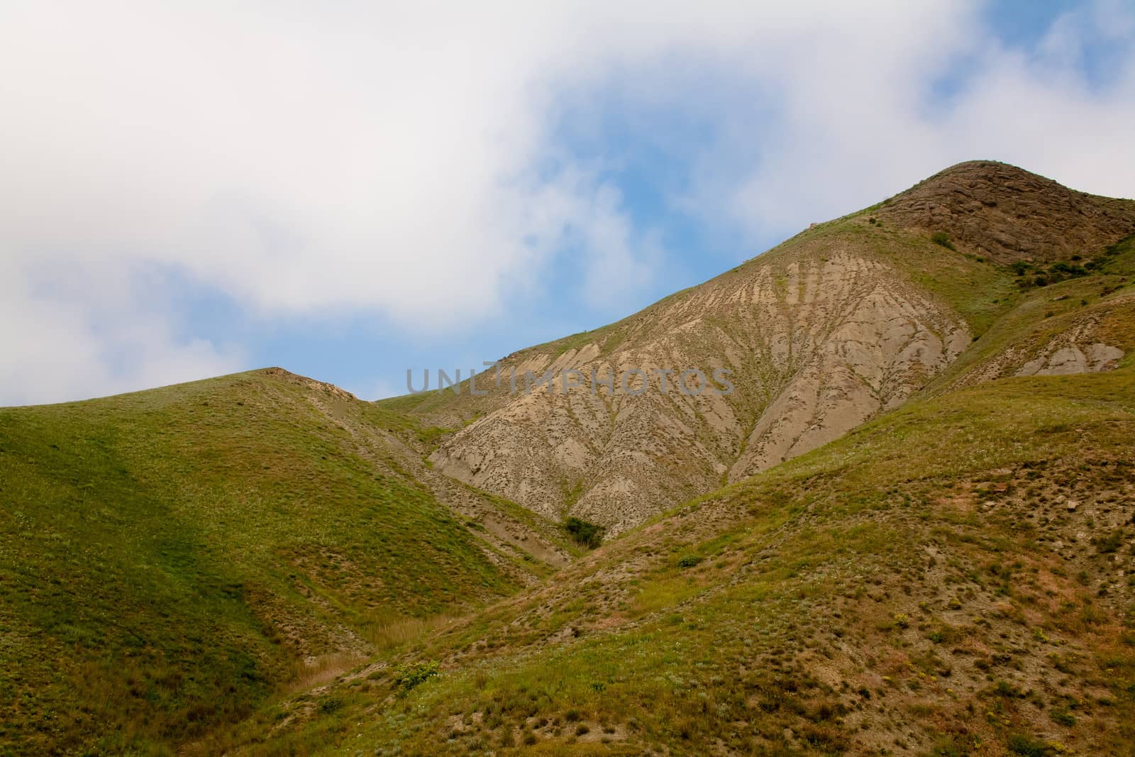Treeless small mountain with green grass in Crimea
