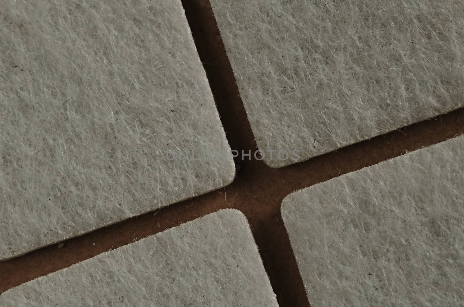 four white squares on a beige background 