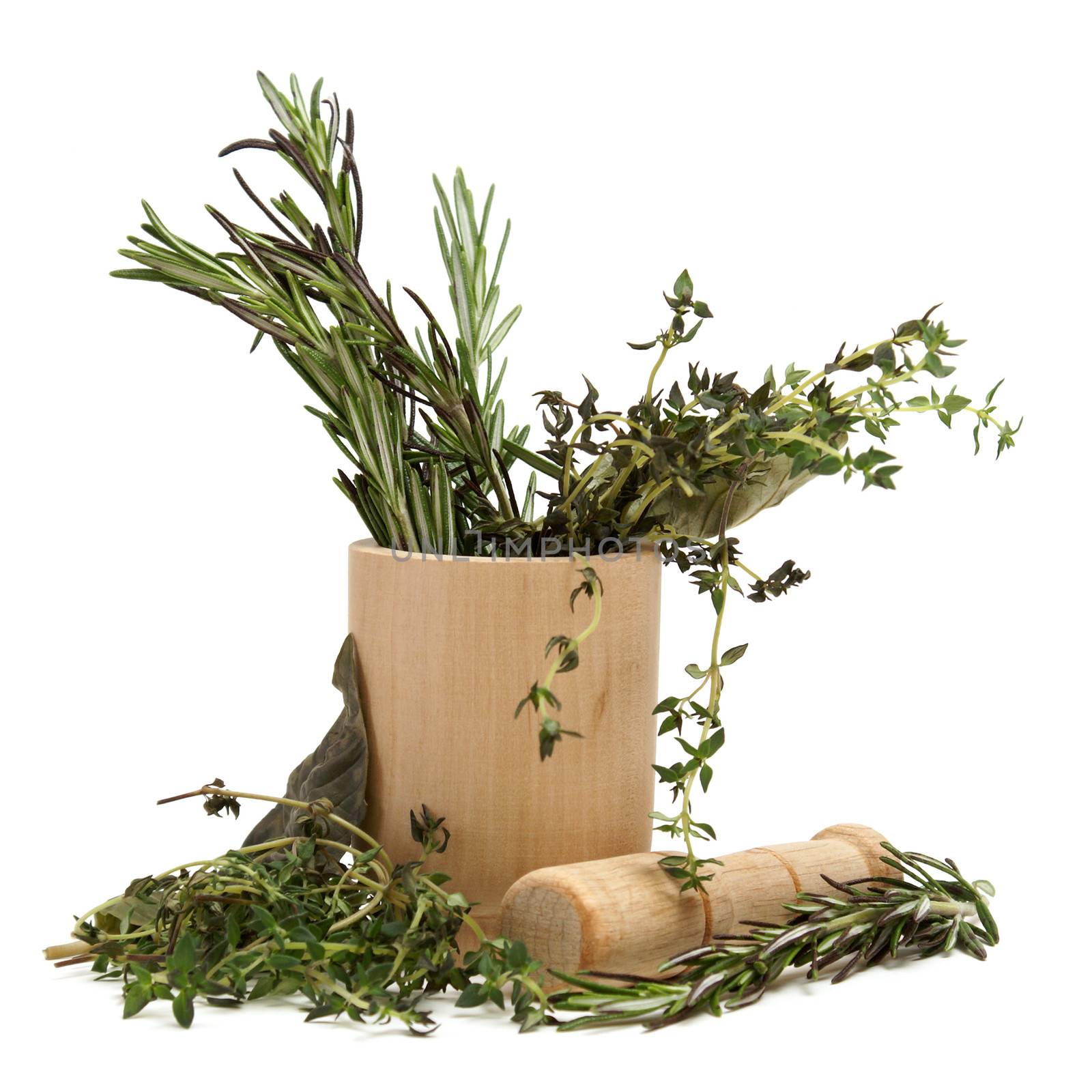 Grinding together several herbs in a mortar and pestle.