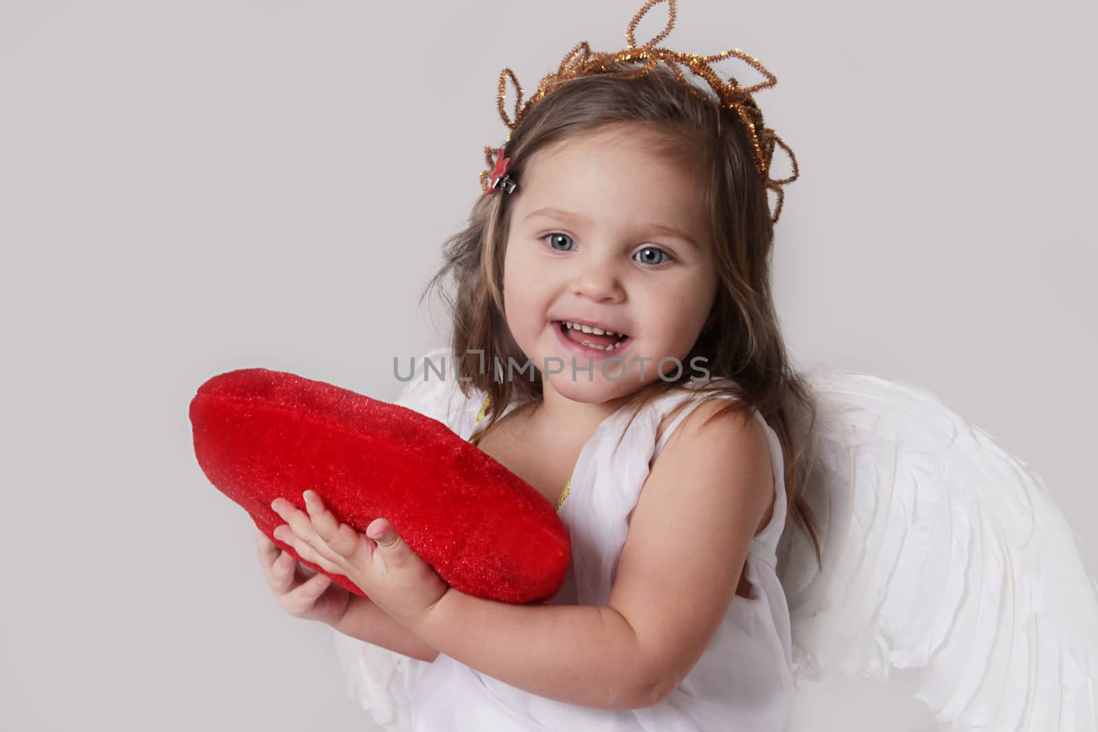 Happy cupid girl holds plush heart by Angel_a