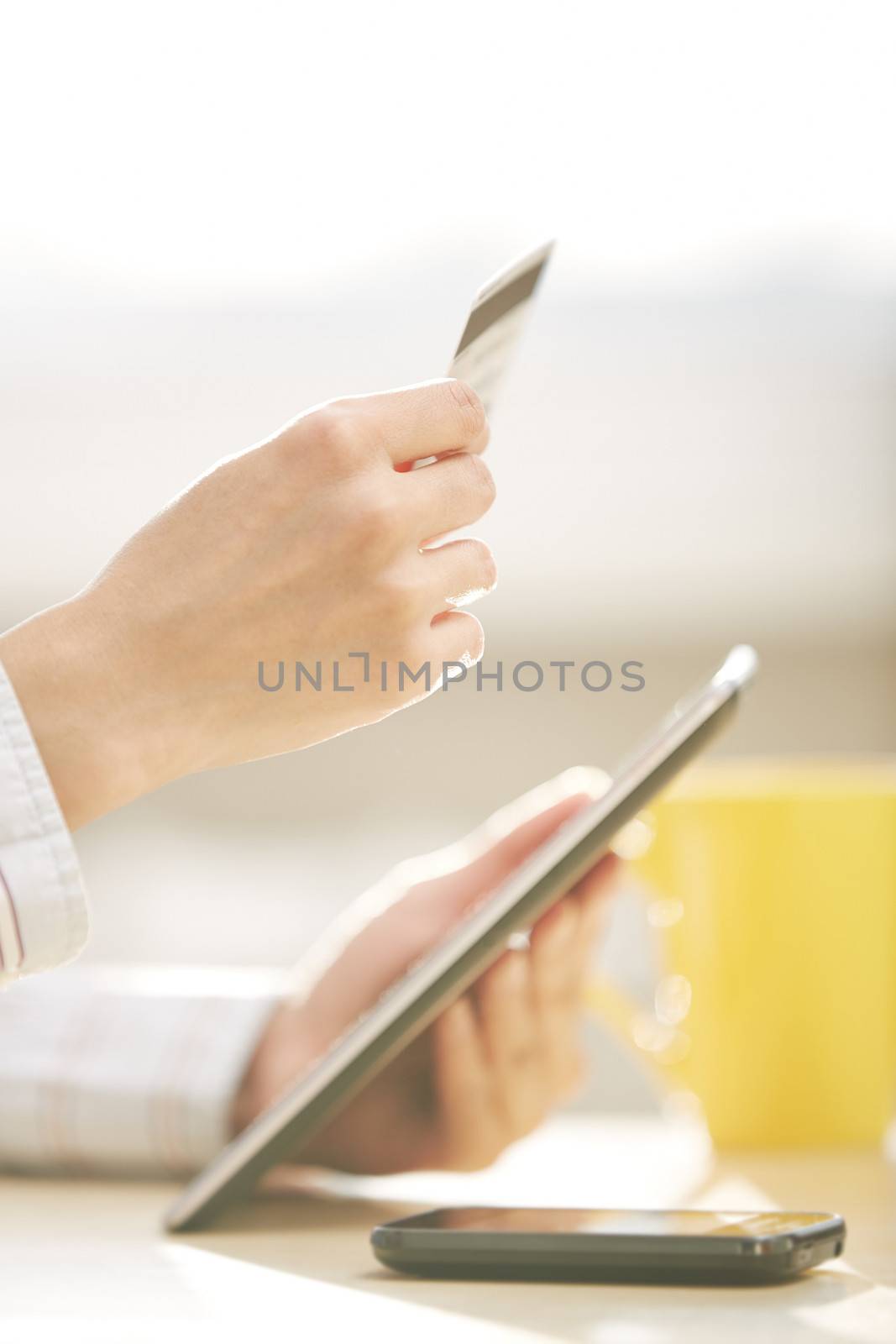 Human hand with tablet PC and credit card during lunch