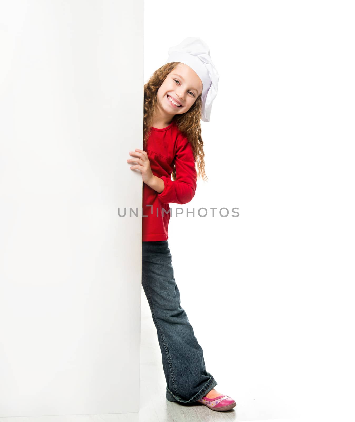 little girl in chef hat with a white board