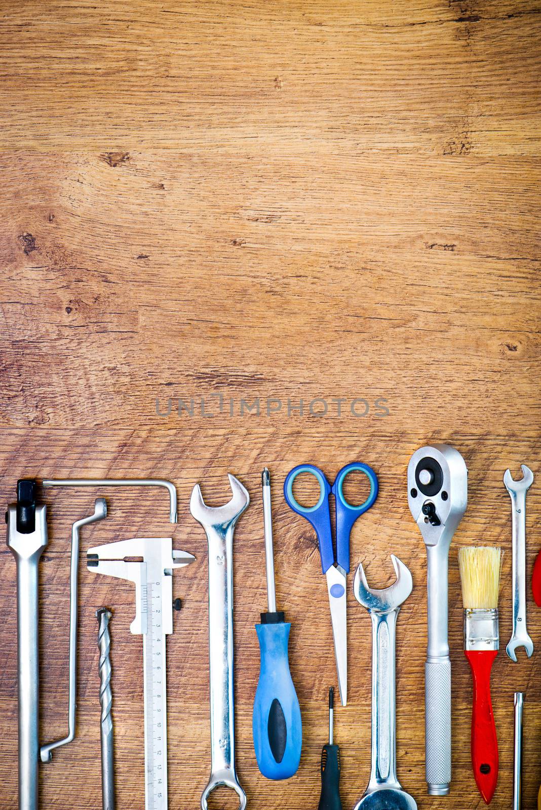 set of tools on a wooden background with place for your text