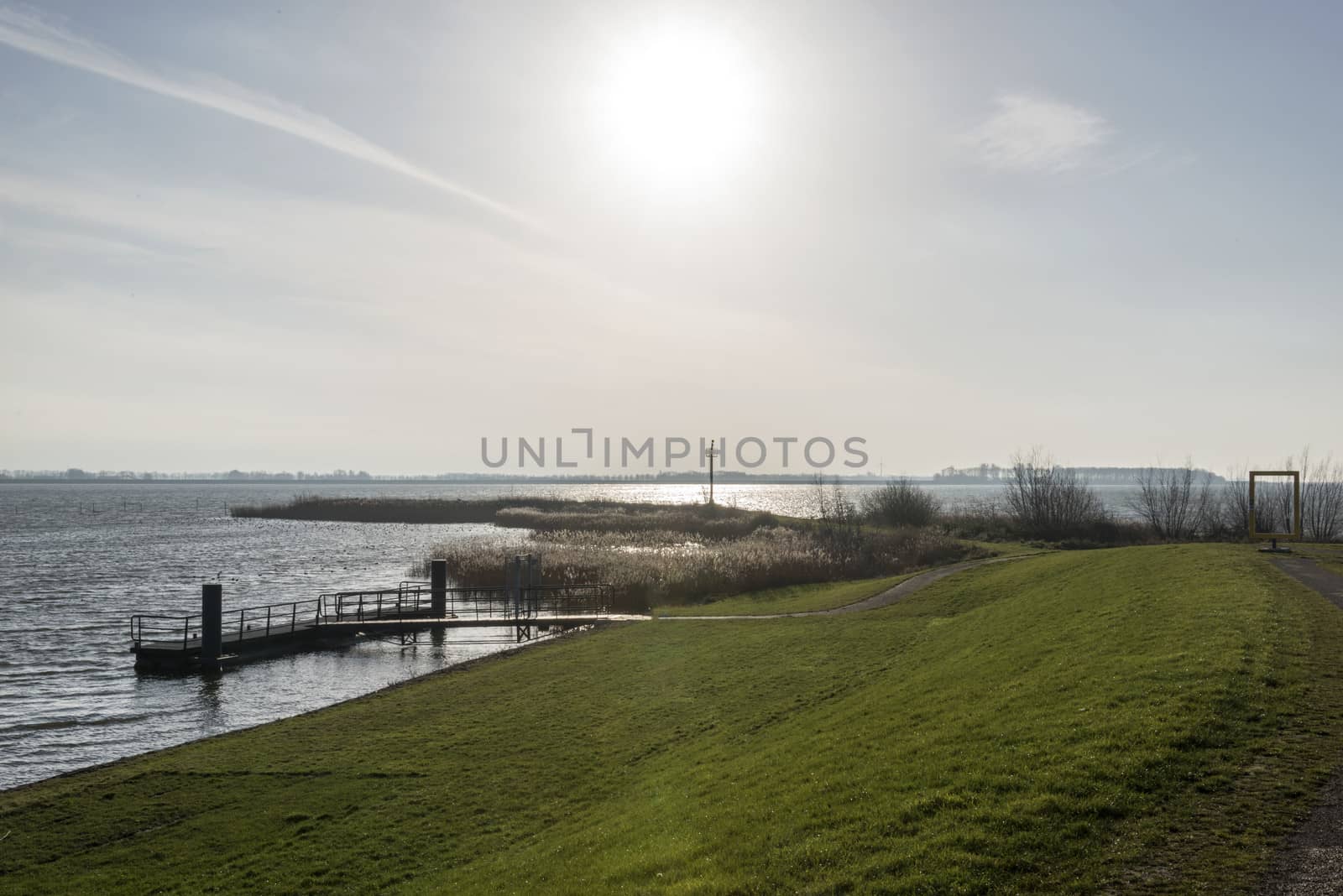 sunshine over dutch ijsselmeer lake in the north of holland