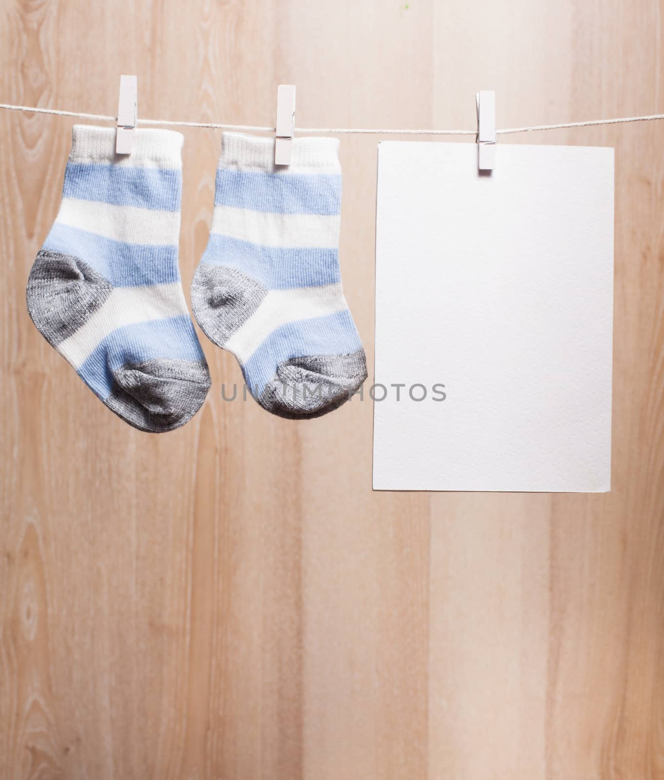 Baby boy socks attached to the rope and blank card for greetings