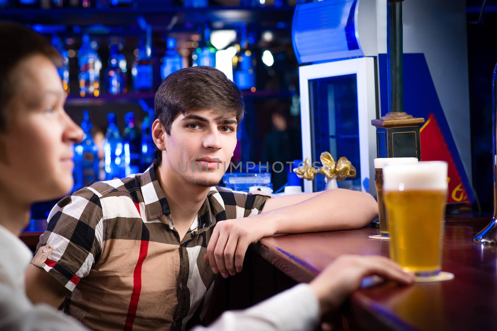 portrait of a young man at the bar, spending time in a nightclub