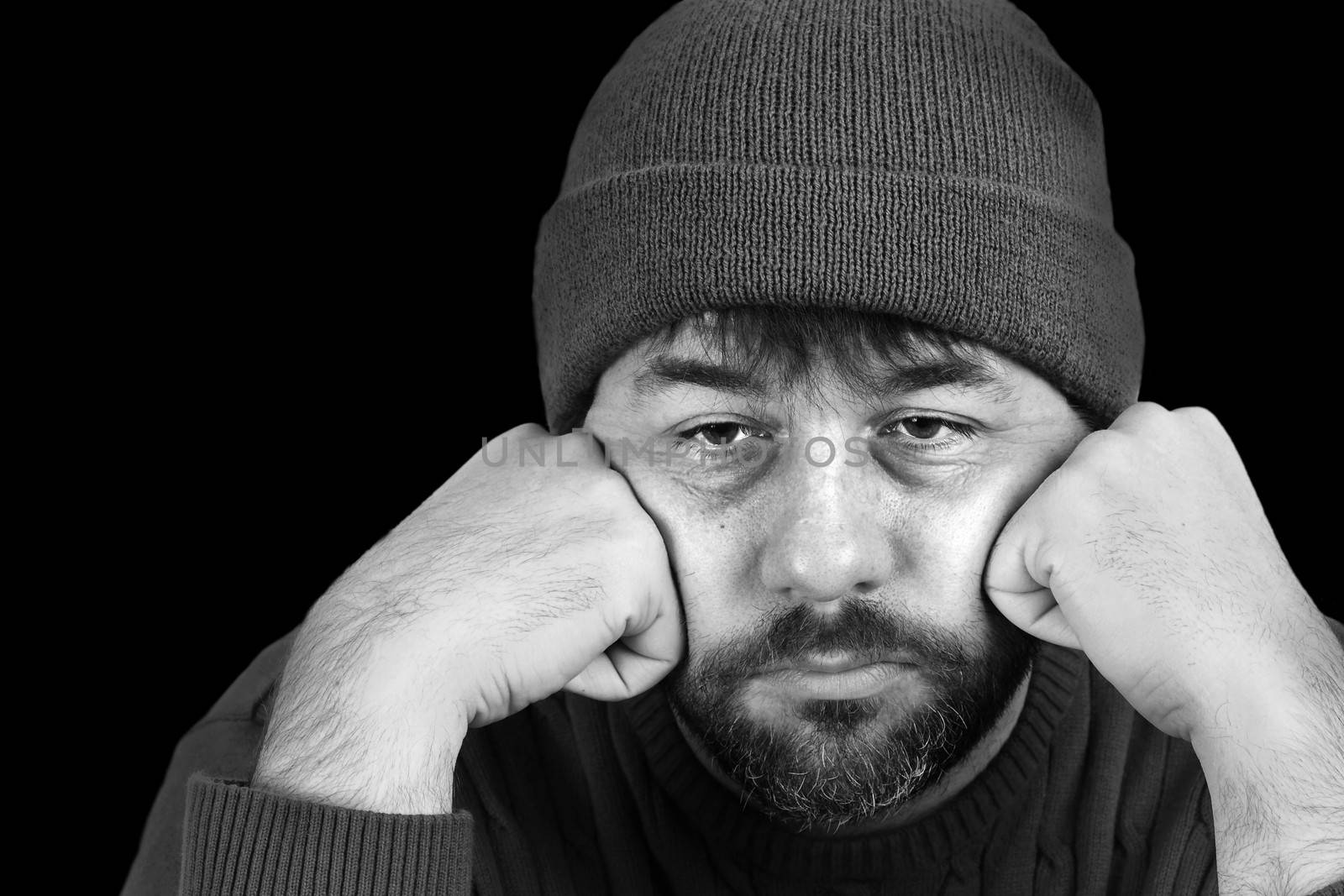 Dramatic black and white portrait of a man in despair