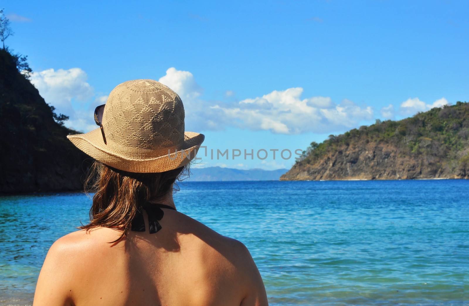 Young woman's back looking at the sea by Mirage3