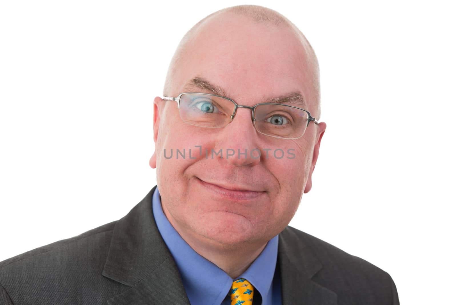 Businessman with a sardonic quizzical expression raising his eyebrows in disbelief as he smiles at the camera, head and shoulders portrait on white