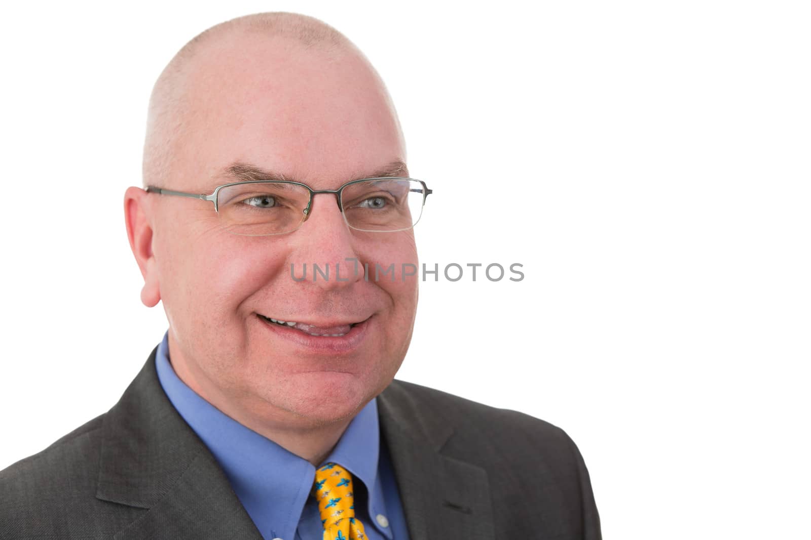 Smiling complacent businessman pleased with his achievements looking to the side with a self-satisfied smile,head and shoulders portrait on white