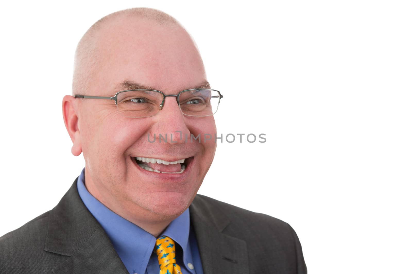 Happy jovial businessman wearing glasses looking to the side with a beaming friendly smile, head and shoulders portrait on white with copyspace