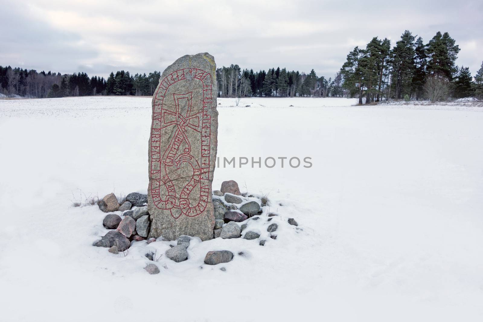 A runestone on a open field in eastern Sweden