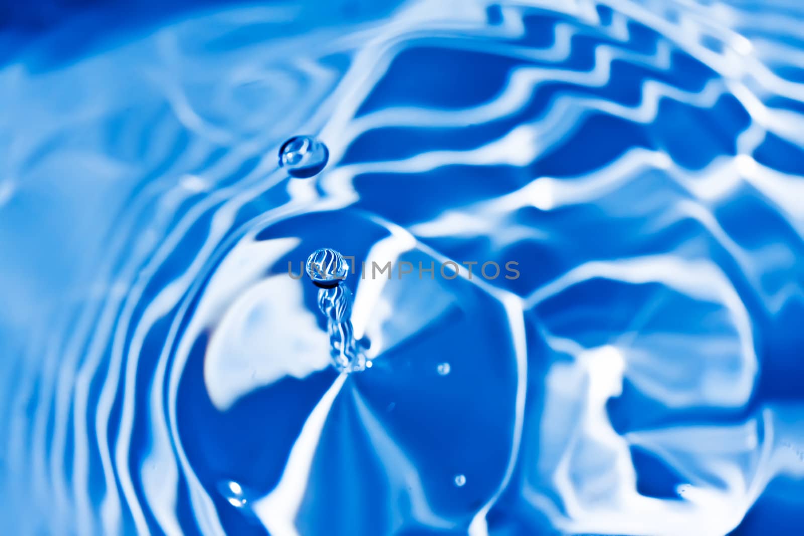 Blue transparent water splashes on white background