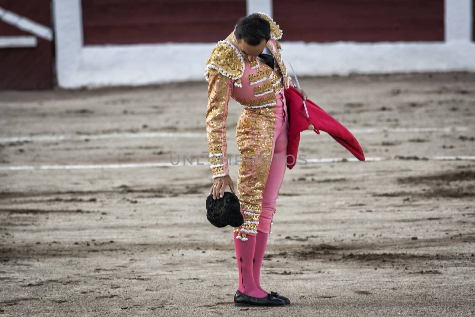 Linares, Jaen province, SPAIN - 28 august 2011: Spanish bullfighter Manuel Jesus El Cid drops his hat on the ground, it is a very old tradition, given that if the hat falls down you give luck to the Bullfighter in his work during a bullfight held in Linares, Jaen province, Spain, 28 august 2011