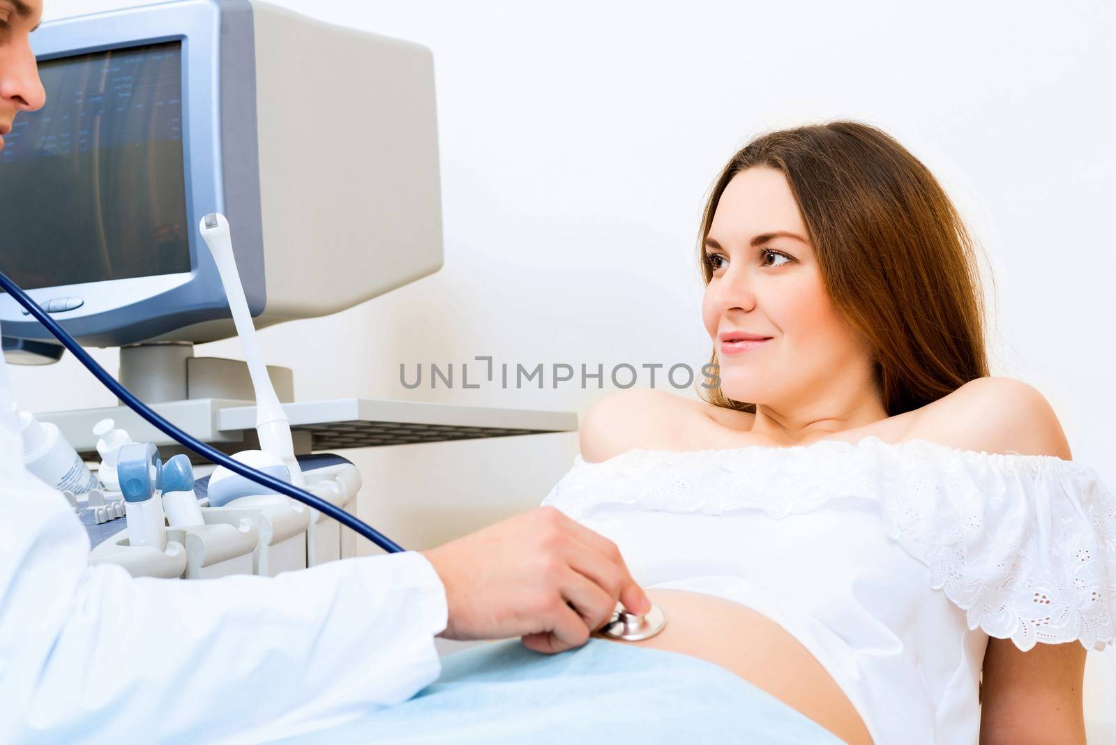 Young attractive pregnant woman on reception at the doctor, health check