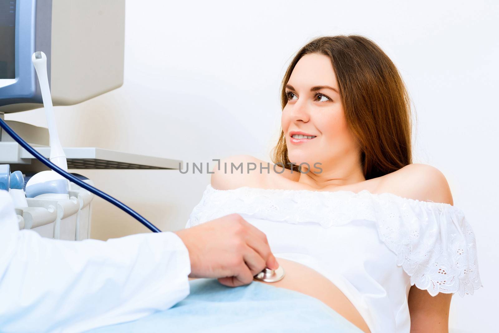 Young attractive pregnant woman on reception at the doctor, health check