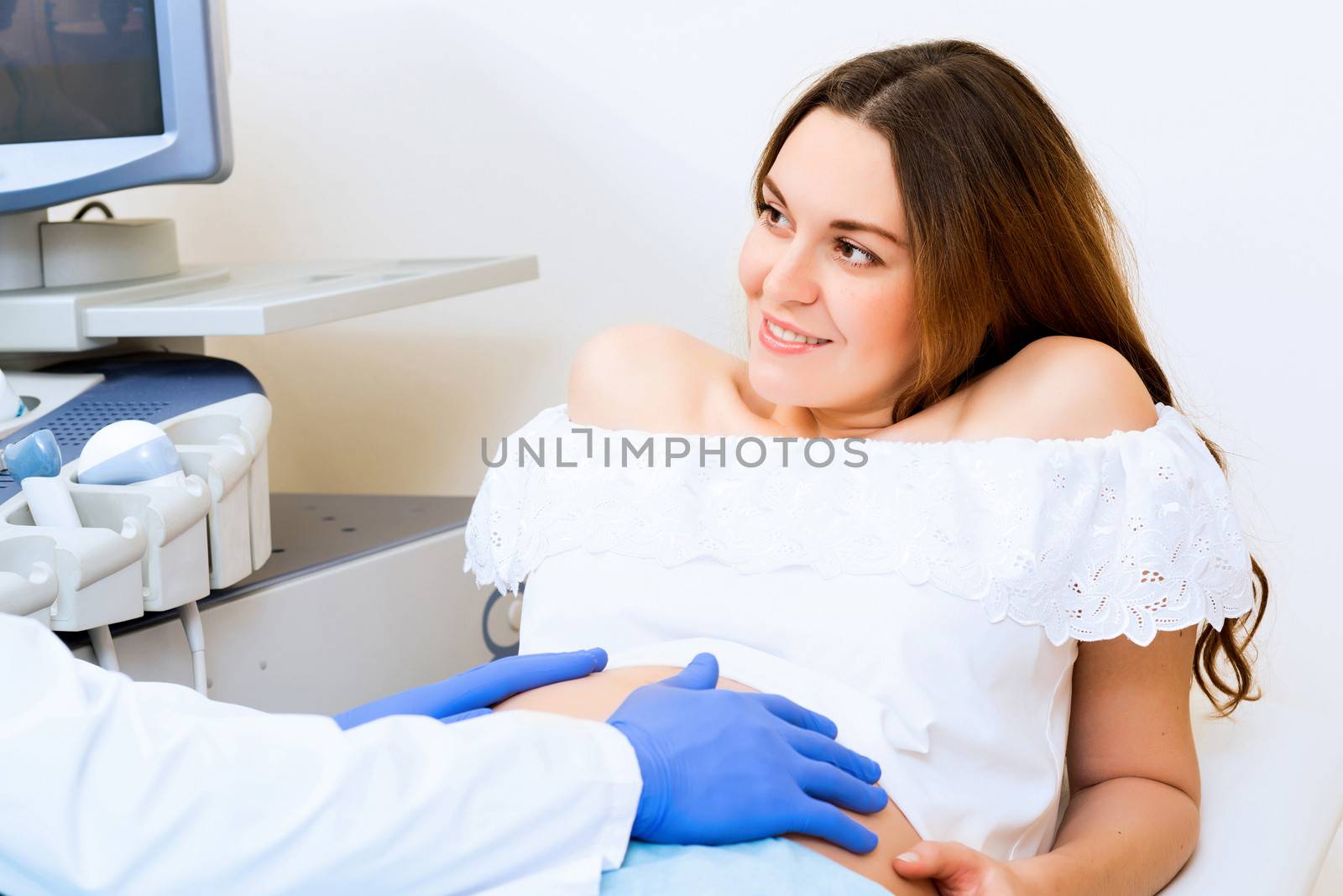 Young attractive pregnant woman on reception at the doctor, health check