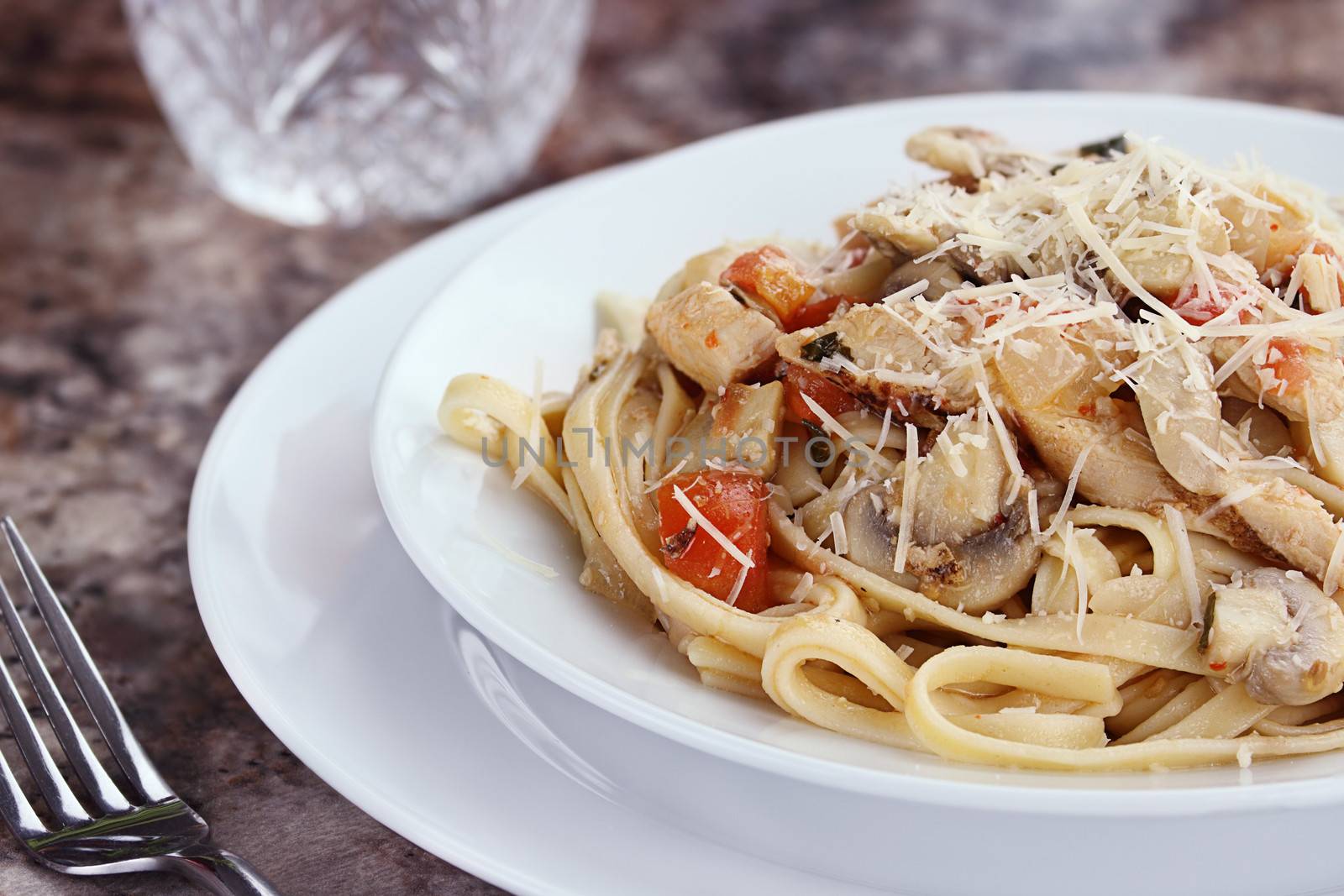 Chicken linguinie with grilled chicken, tomatoes, mushrooms and freshly grated parmesan cheese.