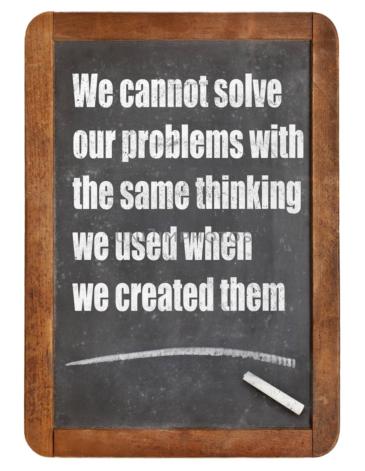 We cannot solve our problems with the same thinking we used when we created them  - a quote from Albert Einstein - white chalk text  on a vintage slate blackboard