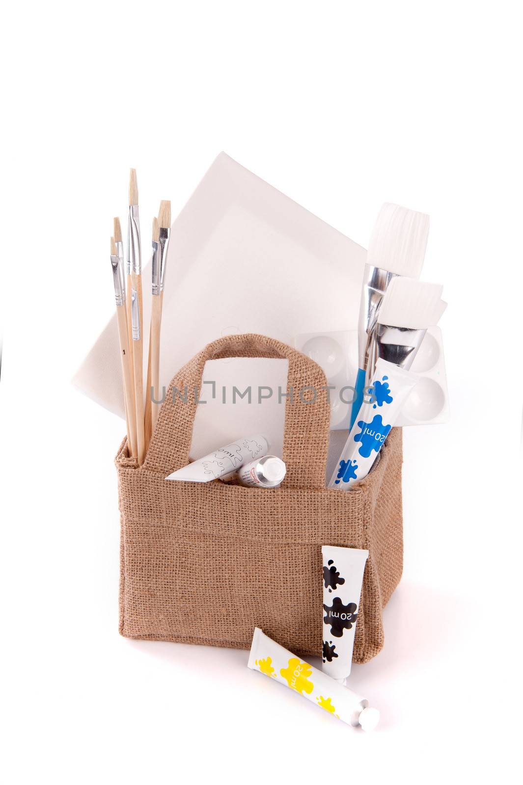 a bag with drawing and painting equipment on a white background