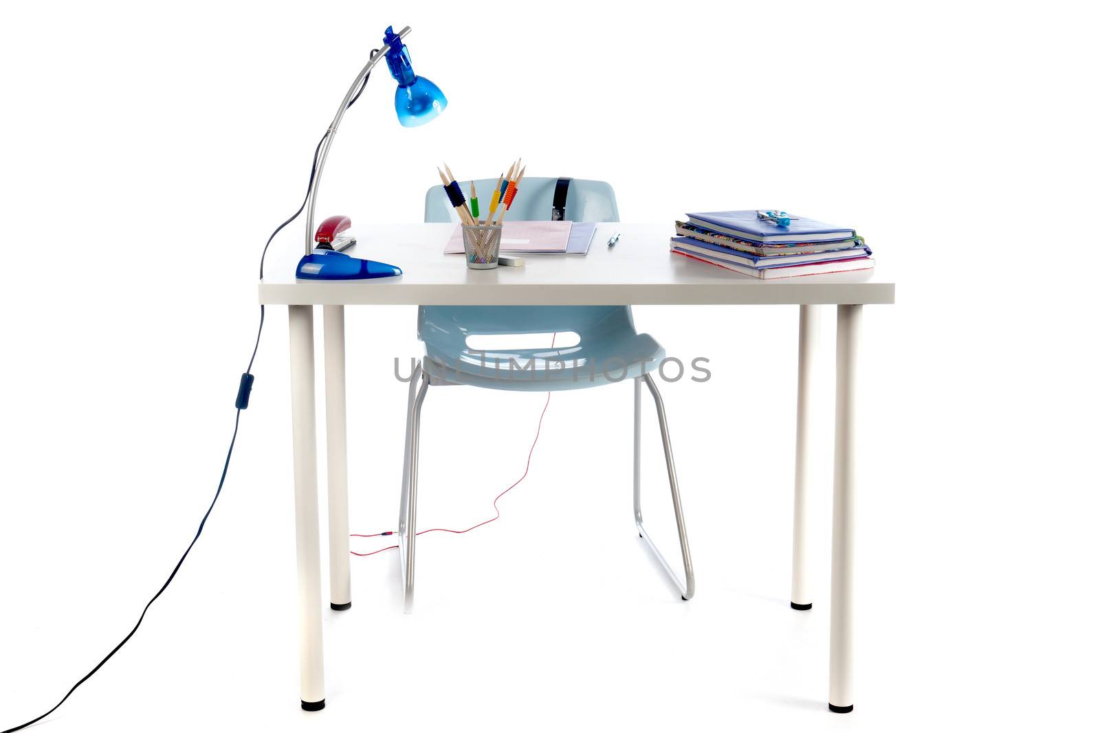 a desk for a teenager to make homework. Desk with books, exercise books, lamp; pen, pencils and a chair.