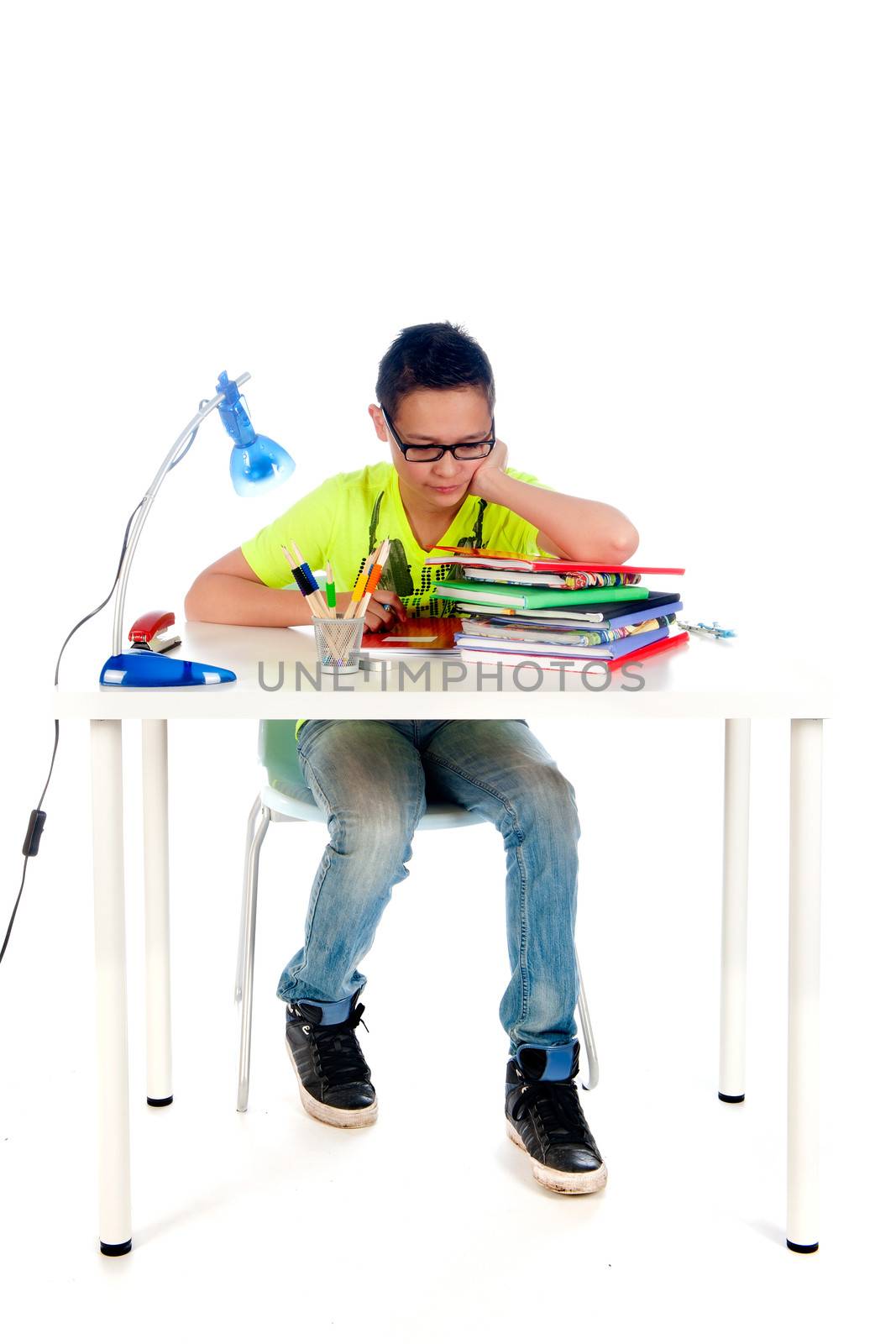 a desk for a teenager to make homework. Desk with books, exercise books, lamp; pen, pencils and a chair.