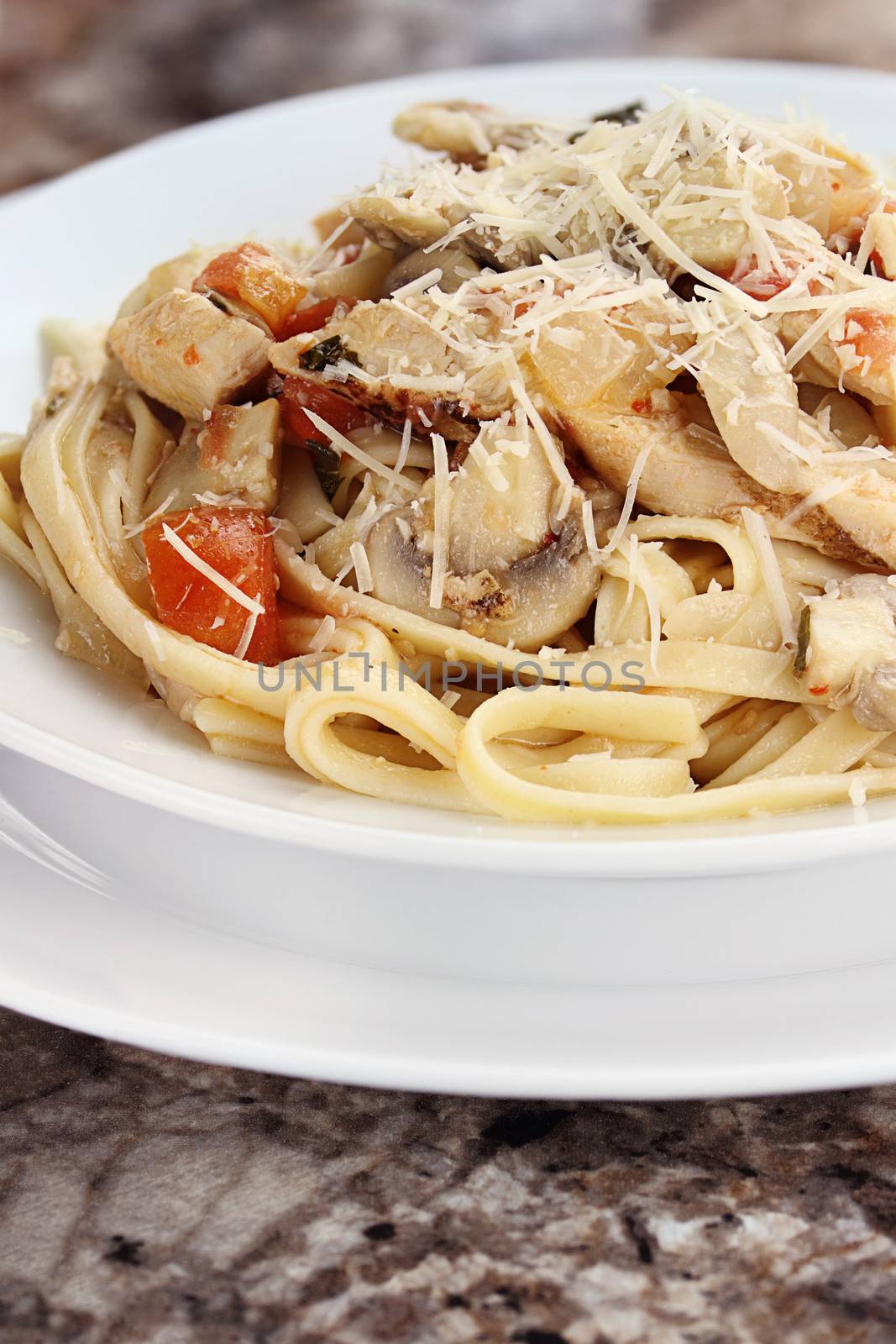 Chicken linguine with grilled chicken, tomatoes, mushrooms and freshly grated parmesan cheese.