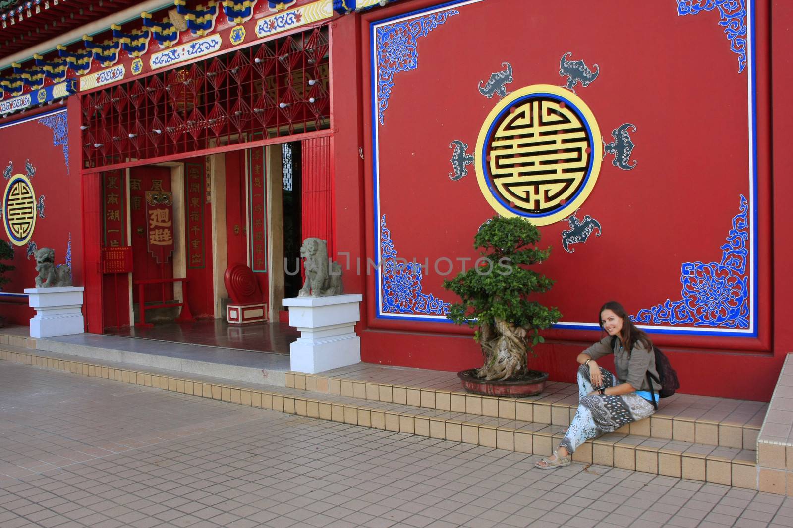 Tourist resting on the stair of Chinese buddhist temple, Bandar Seri Begawan, Brunei, Southeast Asia