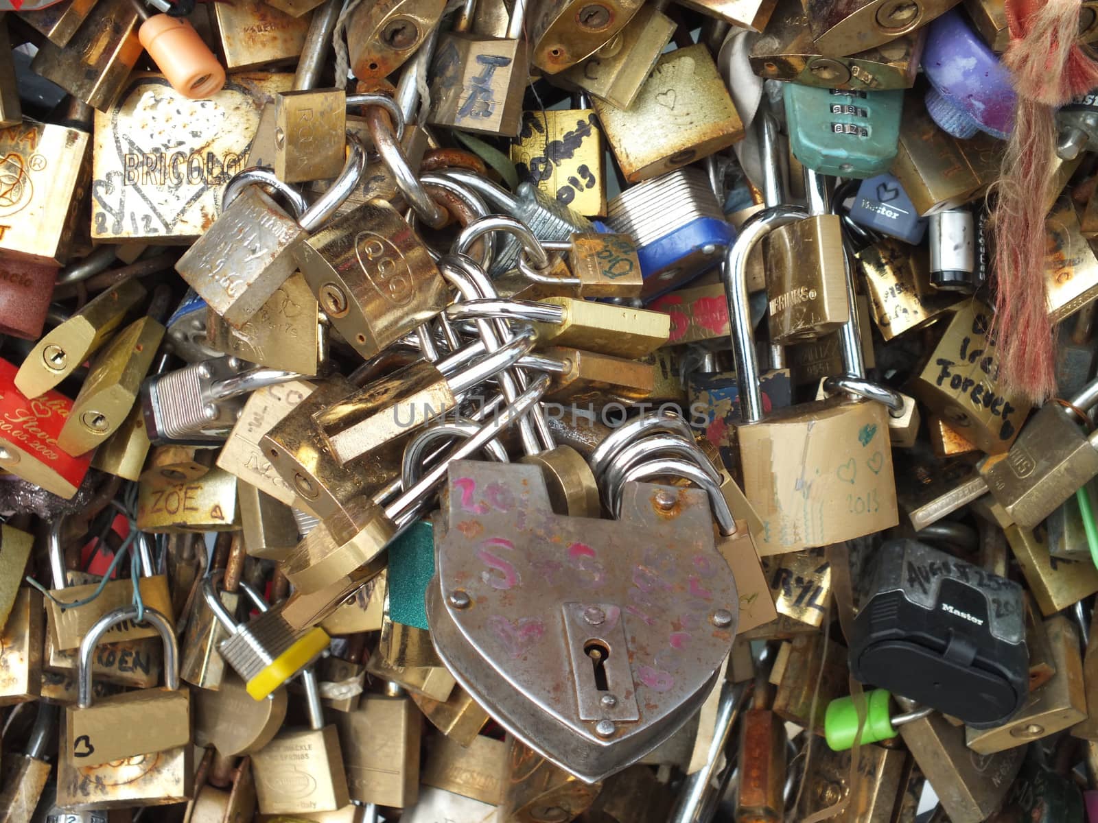 A love lock is a padlock which sweethearts lock to a bridge to symbolize their love and usually their' names or initials are inscribed on it. The key is then thrown away to symbolise unbreakable love.
