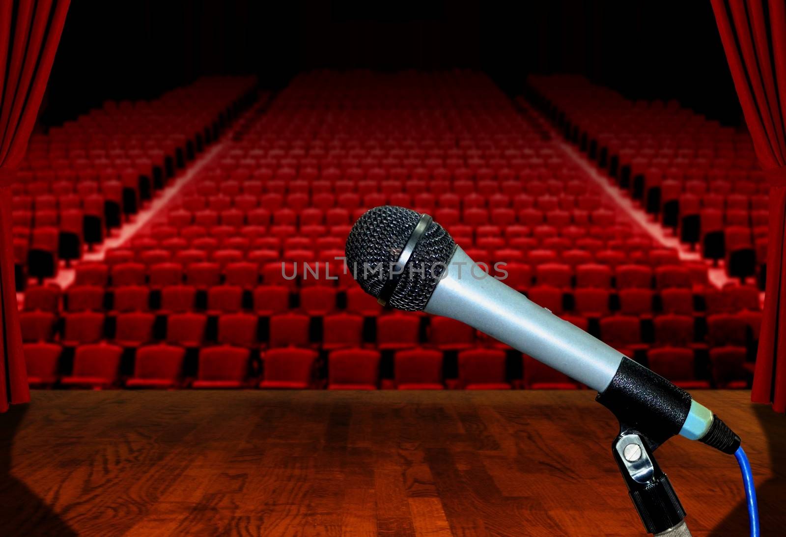 Microphone on Stage Facing Empty Auditorium Seats by razihusin