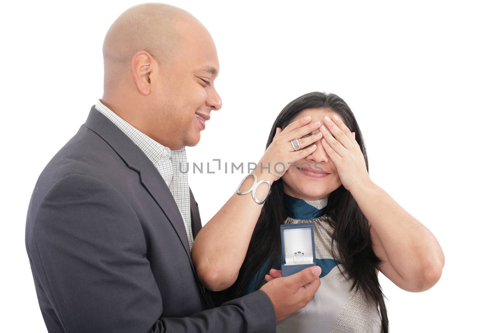 Man about to propose hiding eyes of his girlfriend isolated by dacasdo