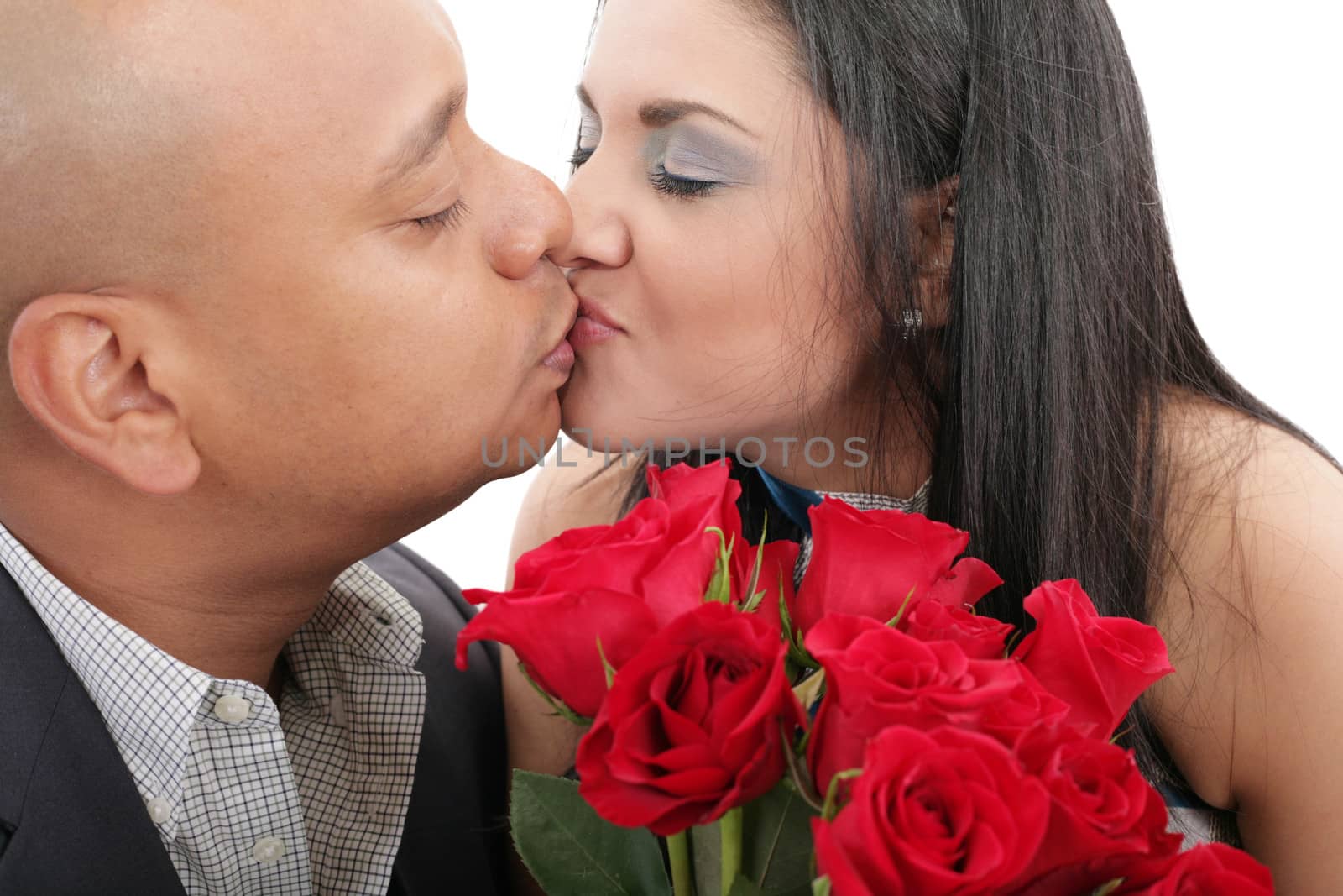 Close up of couple kissing holding a bouquet of red roses