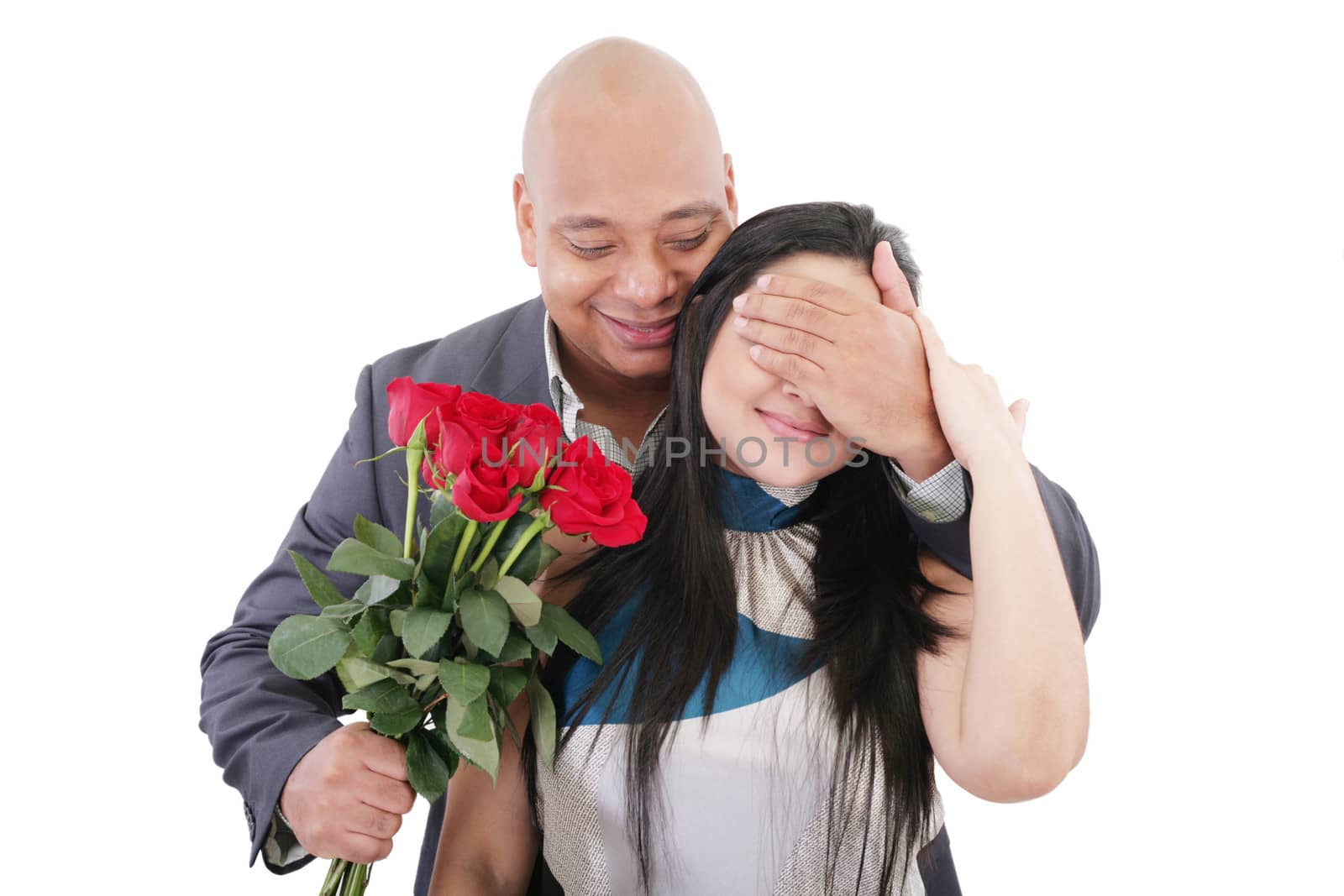 Man offering a bouquet of red roses to a woman