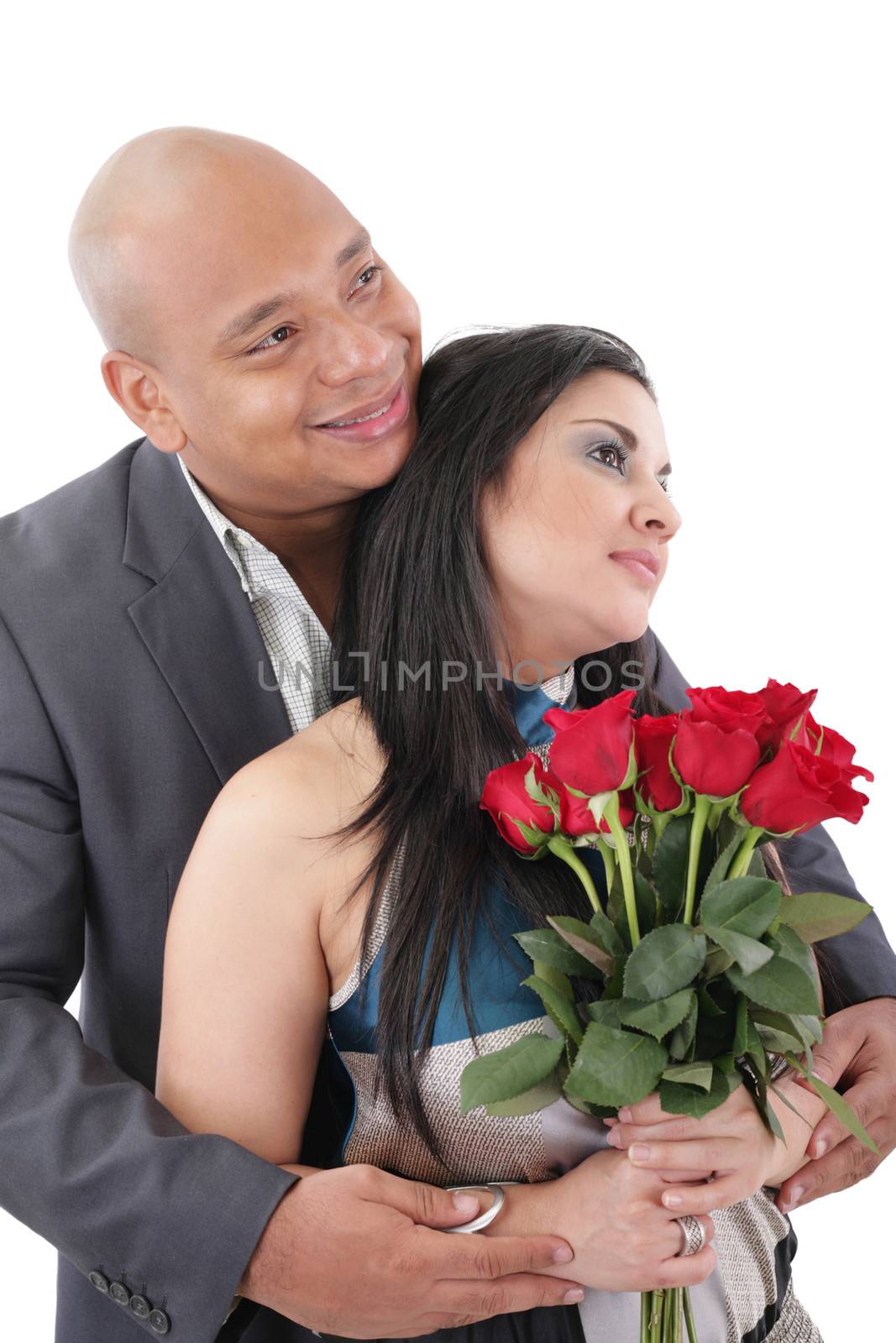 Couple holding a bouquet of red roses looking at a copyspace by dacasdo