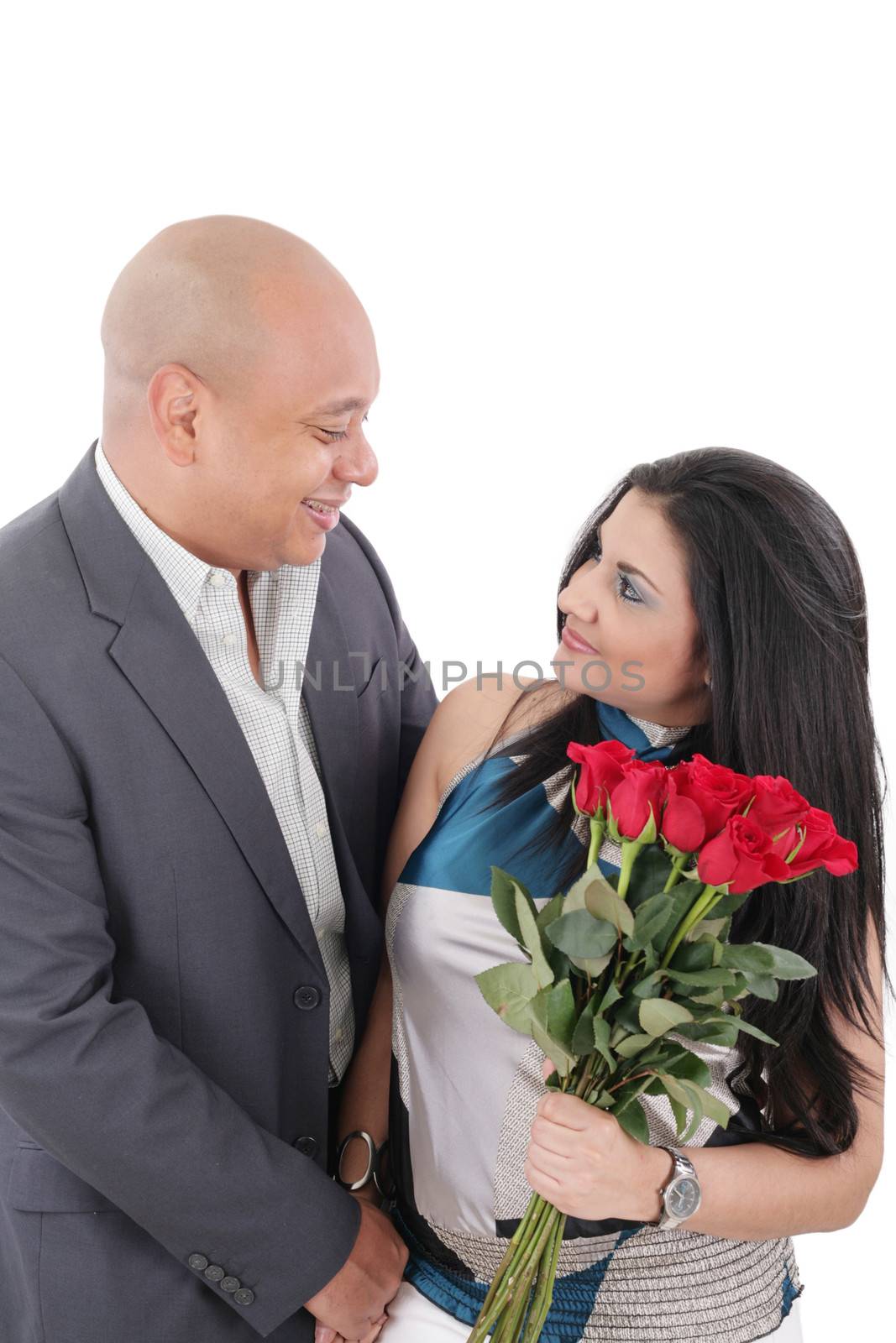 young couple with bouquet of roses looking at each other