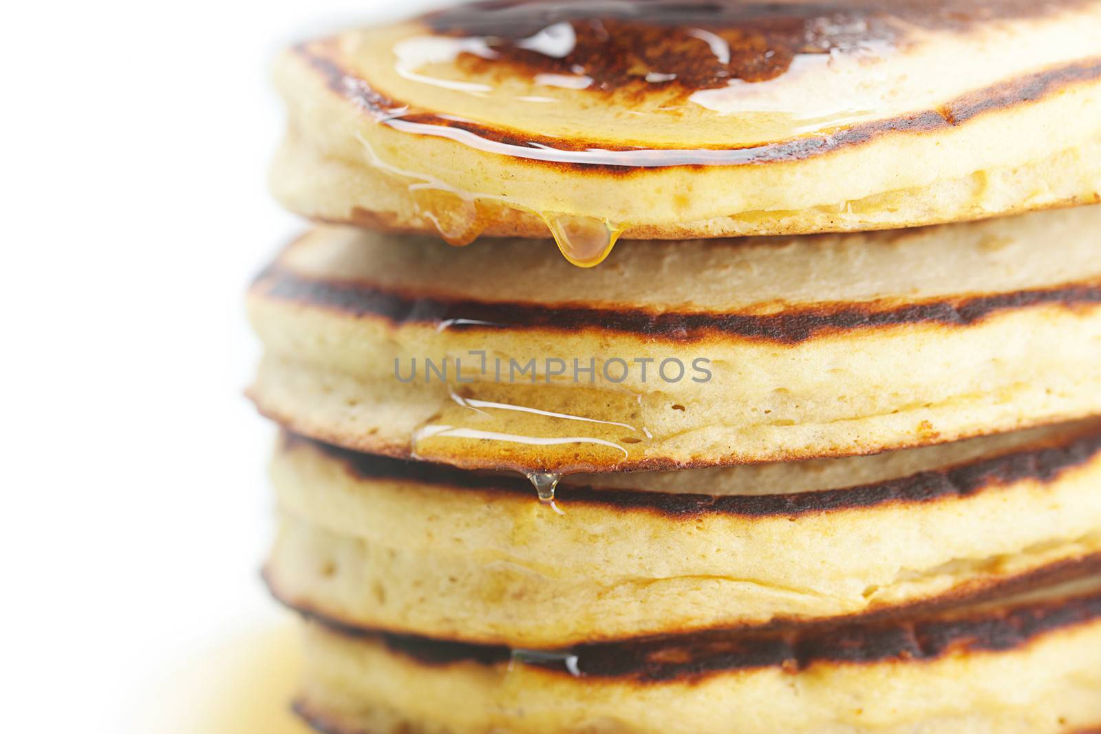 Pancakes and honey isolated on white