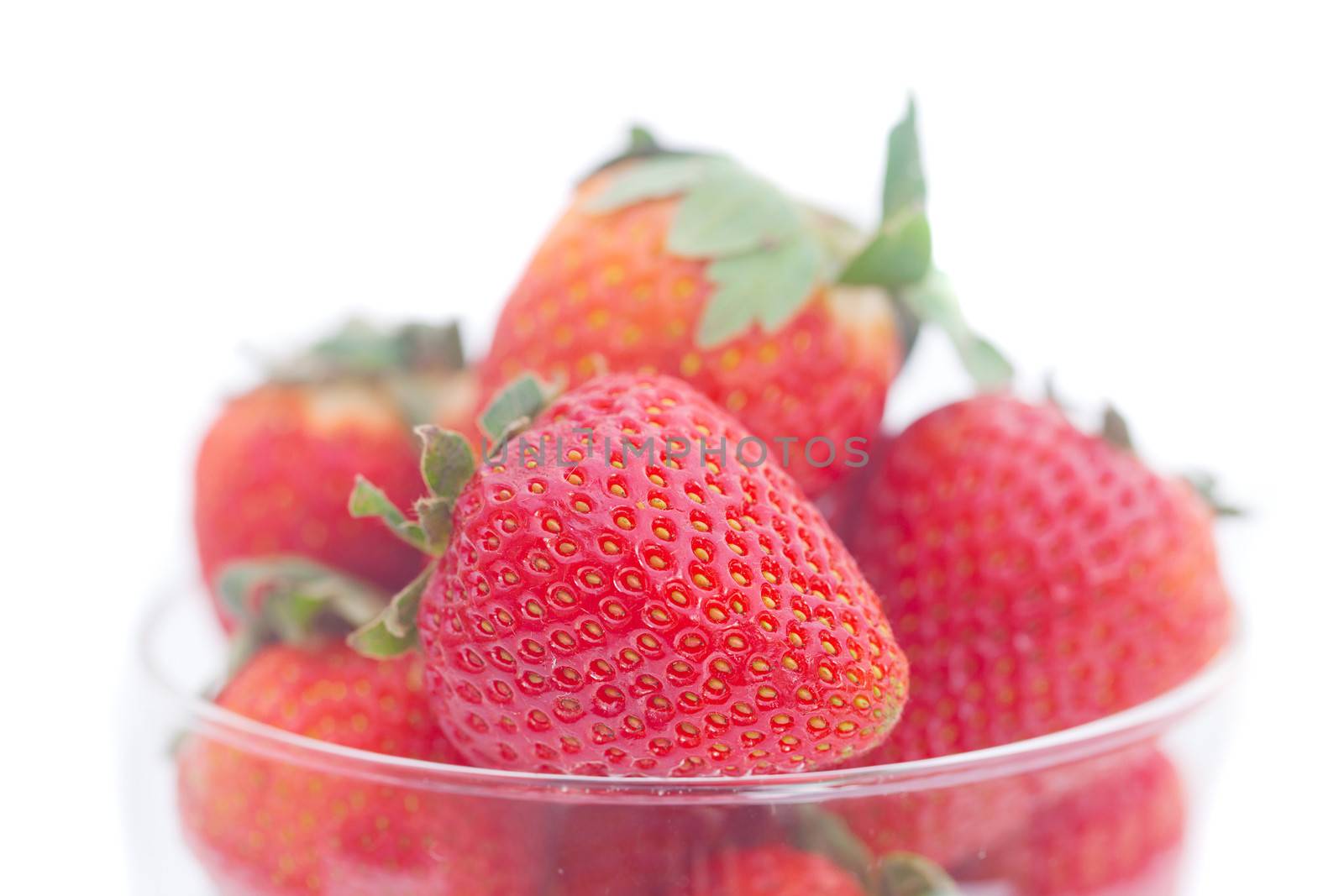 strawberry in a glass bowl isolated on white