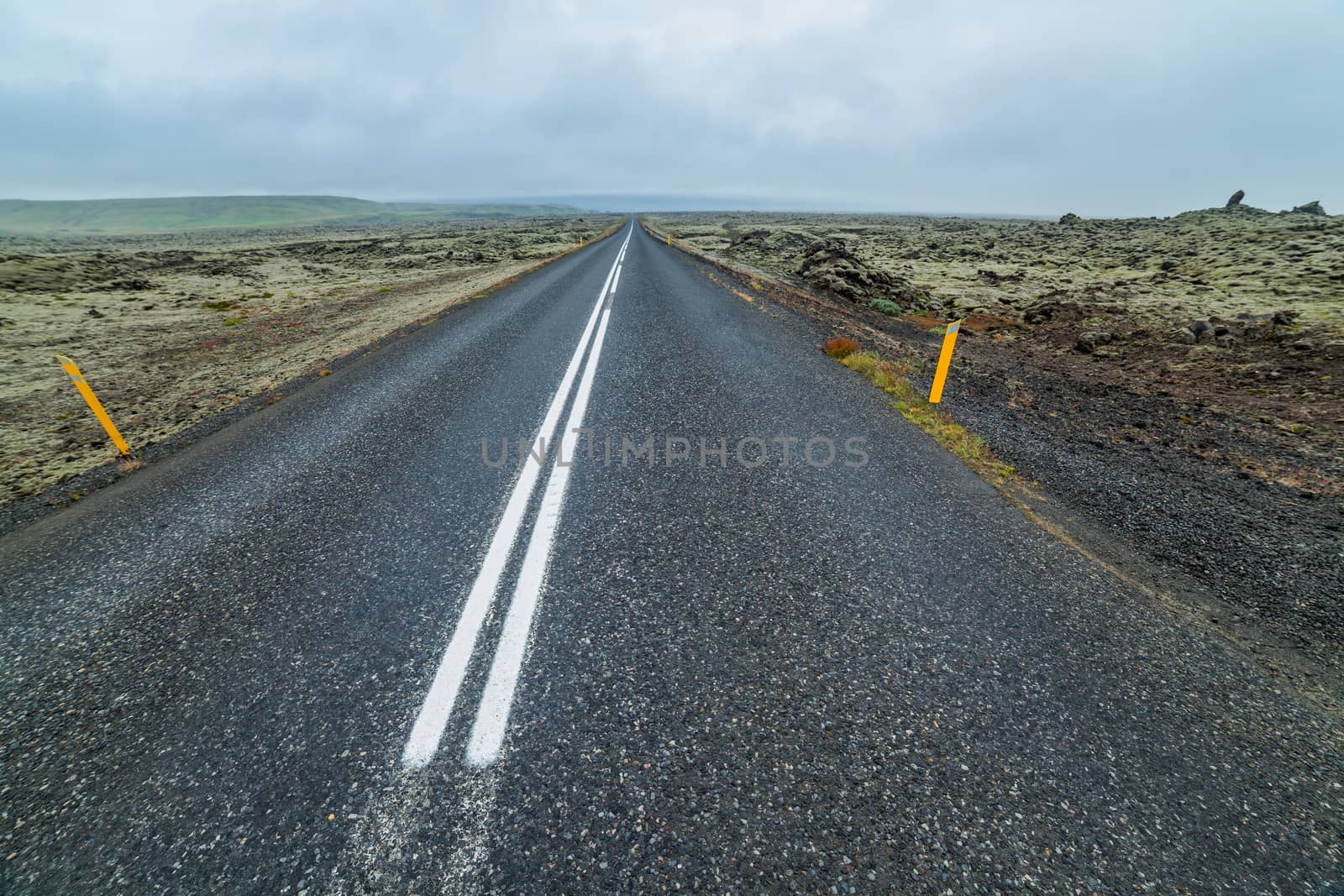 Highway through Iceland landscape at foggy day. Horizontal shot
