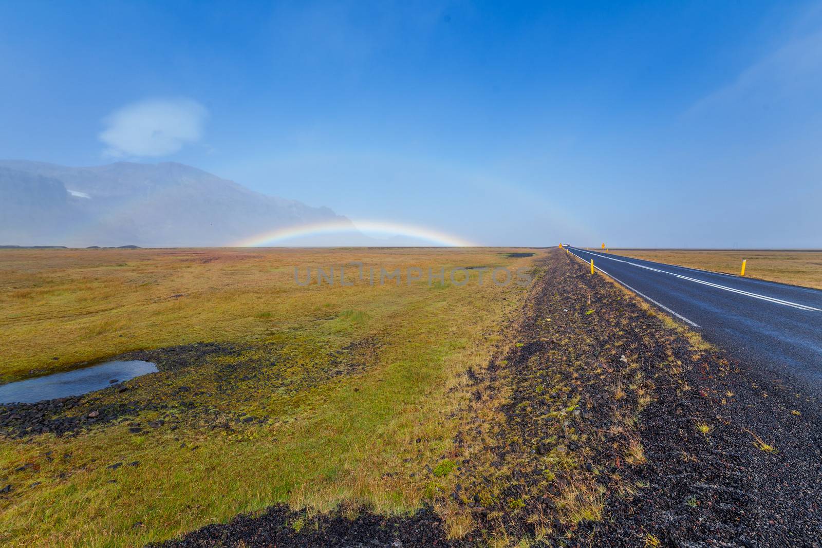 South Icelandic mountain landscape under a blue bright sky with double rainbow