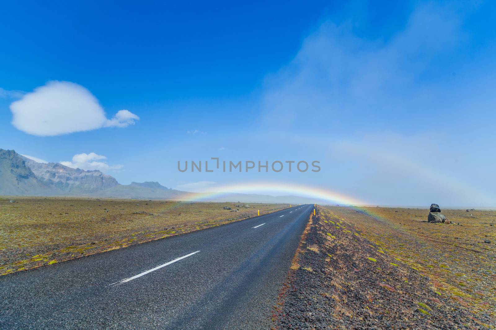 South Icelandic road landscape under a blue bright sky with double rainbow
