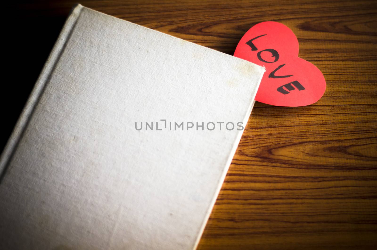notebook with heart letter love on wood background vintage style