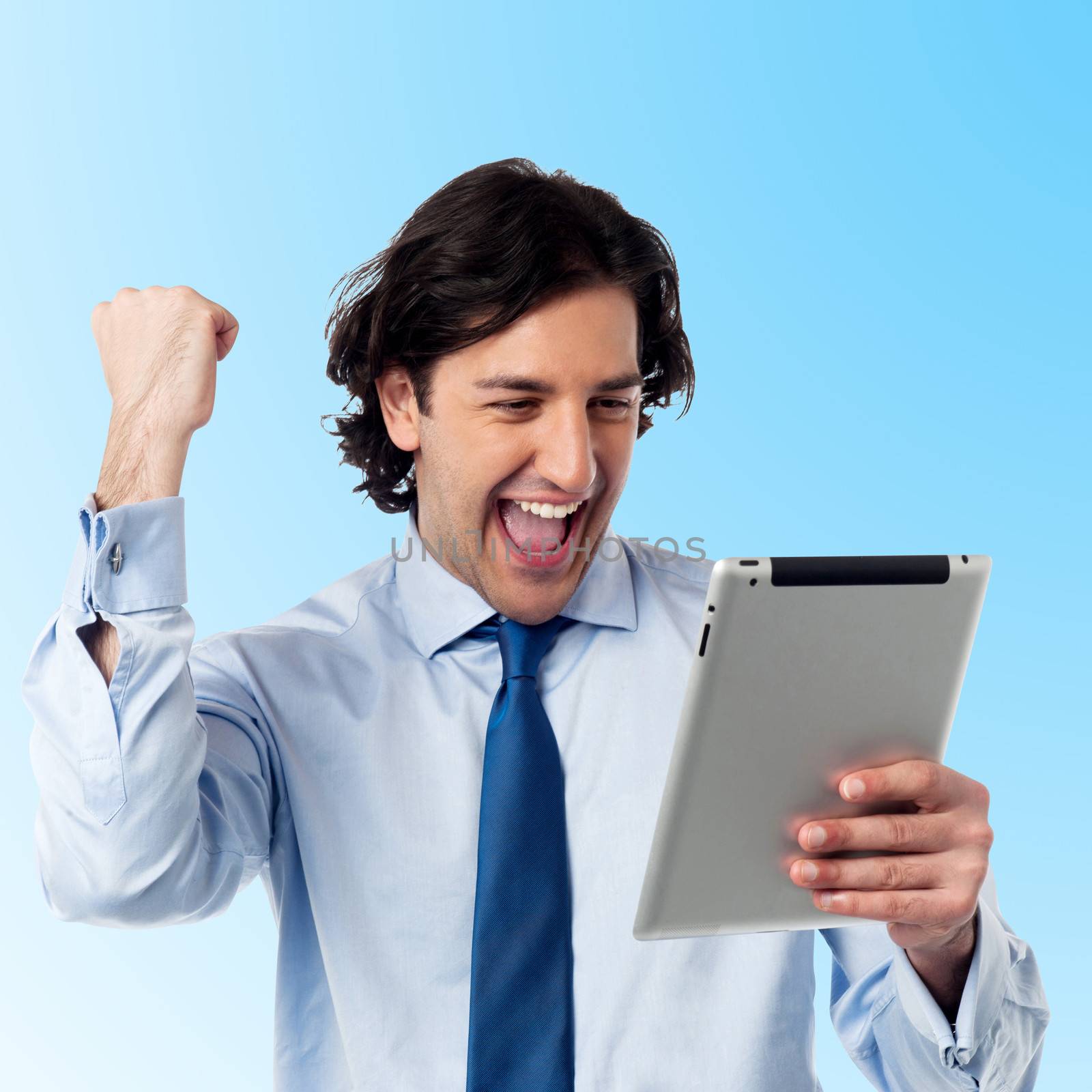 Young excited businessman with tablet pc